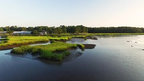 Rising shot of drone flying over Calabash River near downtown Calabash NC at sunrise