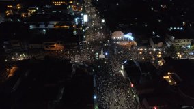 Slow maneuver aerial footage view of Yogyakarta monument or TUGU JOGJA at night during new year celebration and fireworks show