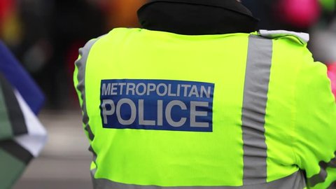 london, United Kingdom (UK) - 01 16 2019: Close up of a London Metropolitan Police officer wearing a high visibility jacket