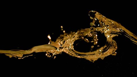 Super slow motion of splashing colawhiskeytea isolated on black background. Filmed on very high speed camera, 1000 fps.