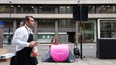 LIVERPOOL STREET, LONDON - MARCH 20, 2019: A homeless person inside a tent in the street in Liverpool Street, East London, UK.