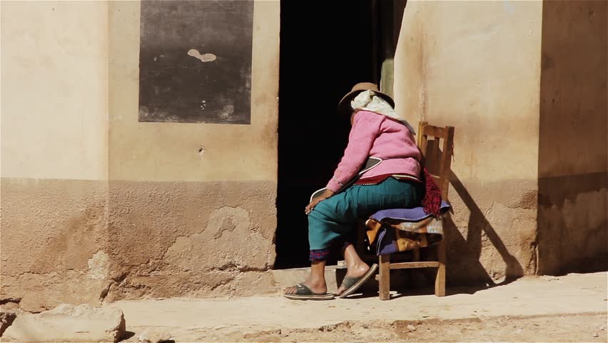 Senior Woman sitting at the Entrance of her House in Susques, Jujuy Province, Argentina. 