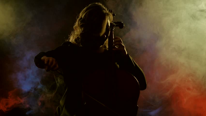 Woman in black plays on cello, black background, smoke | Shutterstock HD Video #1026059378