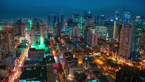Areal night view on the Makati Metro district of Manila - business and shopping city, Luzon island, Philippines. Aerial view Timelapse 4K