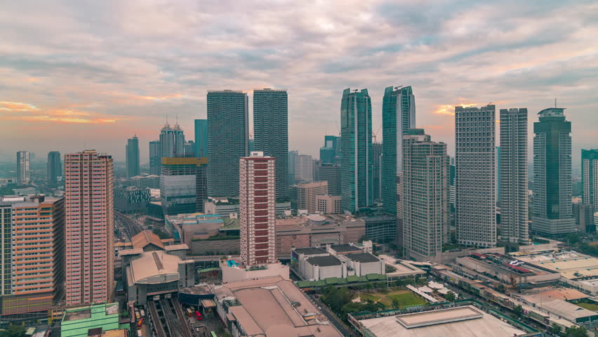 Panorama view sunrise over skyscapers in Manila, Luzon, Philippines. Aerial Timelapse 4K