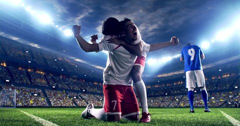 Professional footballer is happy and slides with his hands to the air. Another soccer player runs after him happily. Action takes place on soccer stadium. Stadium and crowd are made in 3D.