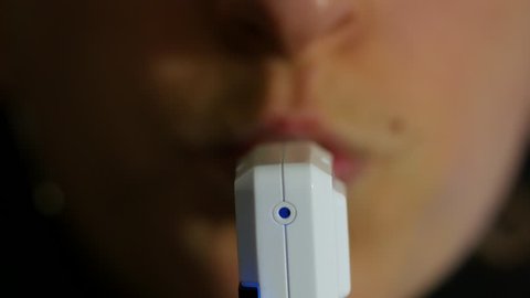 Woman blows into a breathalyzer