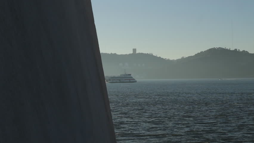 Boat crossing the Tejo river in a foggy morning