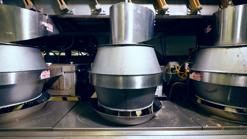 Factory machines wash potatoes before cutting into chips.
