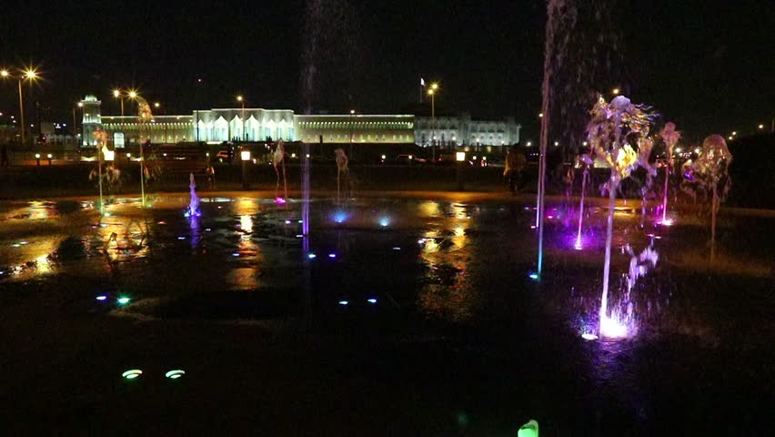 SLOW MOTION: Colorful water fountain at Souq Waqif Park at Doha Corniche illuminated at night. Famous tourist attraction in Doha. Qatar, Middle East, Arabian Peninsula in Persian Gulf.