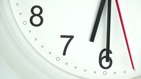 Closeup White clock face The beginning of time 06.30 am or pm. with Black numbers and arrows, Red second hand minute Walk slowly.