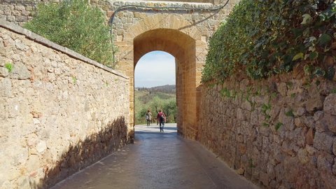 Siena, Italy: Main entrance of medieval village of Monteriggioni within the defensive walls in Tuscany; architecturally significant, referenced in Dante Alighieri's Divine Comedy