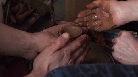 master class in pottery. potter's wheel and hands