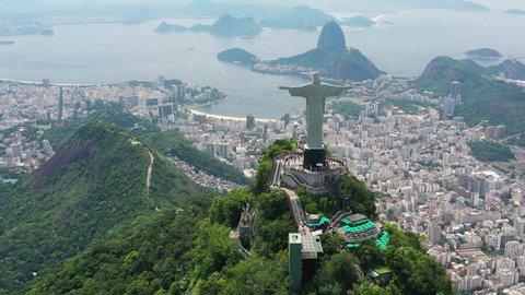 RIO DE JANEIRO, BRAZIL - CIRCA 2016: Aerial view of Christ the Redeemer (monumental statue of Jesus Christ) on top of Corcovado mountain, famous city panorama with Sugarloaf Mountain in background.