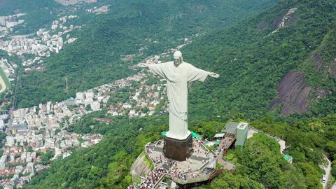 RIO DE JANEIRO, BRAZIL - CIRCA 2016: Aerial view of Christ the Redeemer (monumental statue of Jesus Christ) on top of Corcovado mountain, cityscape of Rio de Janeiro in background.