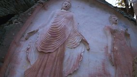 4K video of Buddhist carving art on the rock in Huai Pha Kiang temple, Thailand.