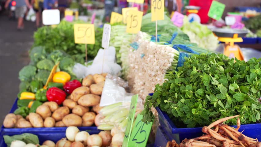 At the outdoors market: Gliding Shot of the Fresh Produce Section of the Market. Exotic Fruits and Organic Vegetables on Sale in the Market. Thailand, Pattaya.