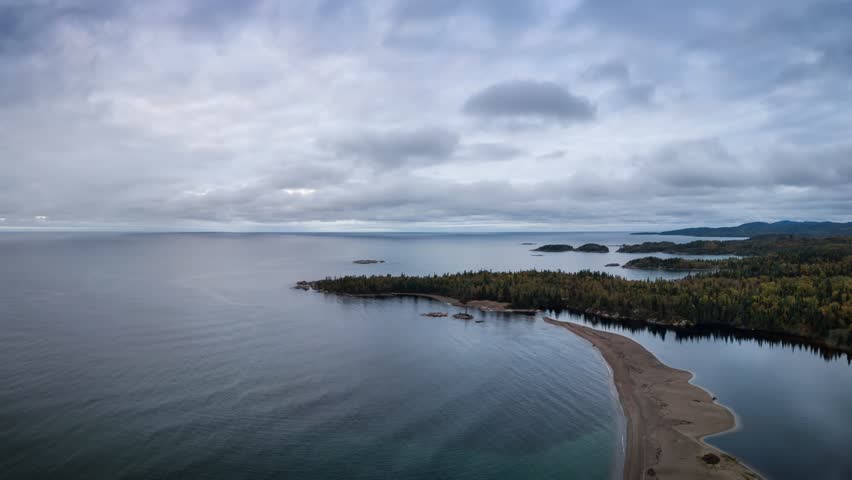 Aerial view of a beautiful beach on the Lake Superior during a vibrant cloudy sunrise. Taken in Terrace Bay, Ontario, Canada. Still Image Continuous Animation