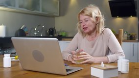 Sequence of videos with middle-aged Caucasian woman sitting at kitchen table in front of laptop screen and telling online female doctor about throat inflammation