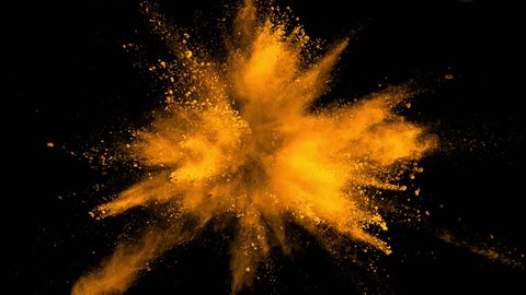 Super slowmotion shot of golden powder explosion isolated on black background.