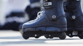 Footage of skater boy wearing aggressive inline roller blades for extreme skating in skatepark.Popular action sport for youth.Video of roller skates in close up