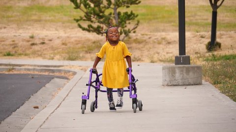 Girl with Cerebral palsy using her walker for mobility