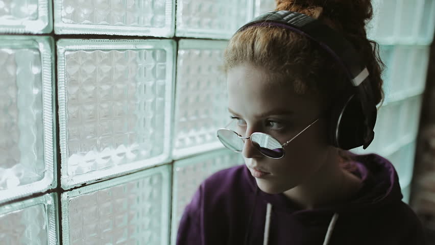 Girl dancing while standing near the window