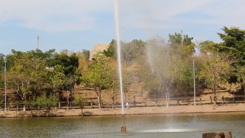 fountain in the middle of a pond