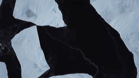 Aerial drone footage of ice on a frozen lake in sunset light.  Establishing shot for winter for climate change. - Powered by Shutterstock - Get 15% off with code: PIKWIZARD15