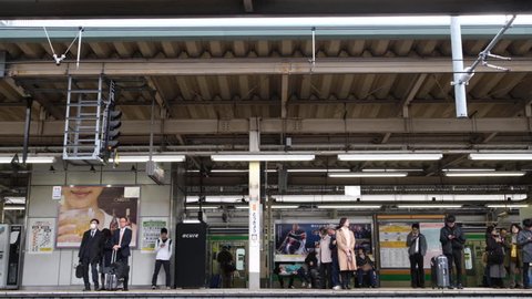 TOKYO, JAPAN - MARCH 20TH, 2019. Commuters at Tokyo Railway Station  platform in a an early morning.