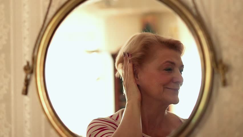 Senior, happy woman checking her look in front of the mirror, slow motion
 Royalty-Free Stock Footage #1026150836