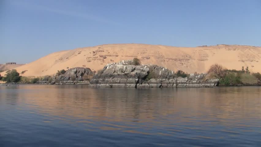 Sand Dune and Grey Rocks Adjacent to the Water of the River Nile in Egypt