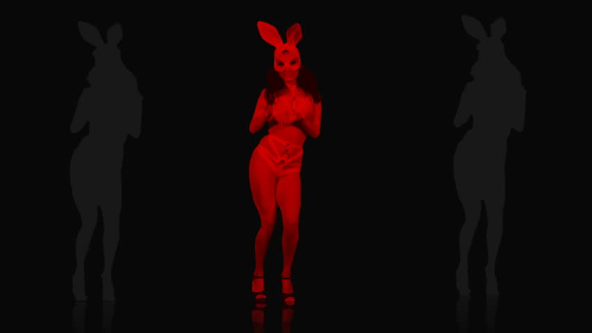 Amazing Go Go Girl jumping in bunny rabbit costume and white mask on colorful motion background with strobing effect. Video Art Vj Loop