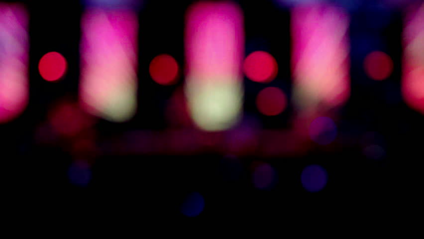 Blurred colorful blinker lights flashes effects background night scene in party night club music festival concert on the stage.