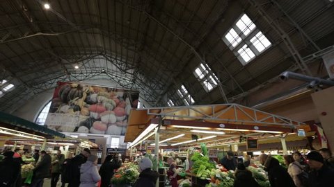 RIGA, LATVIA - MARCH 16, 2019: Riga Central market meat pavilion, people buying fresh food - Former zeppelin hangars - Rigas Centraltirgus