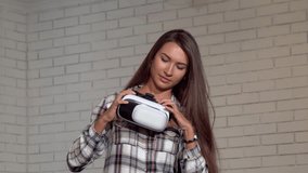 Attractive young woman looking excited, using virtual reality glasses