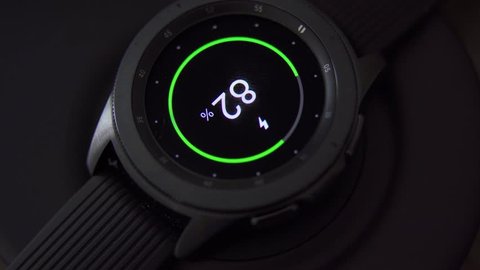 JAKARTA, Indonesia - March 19, 2019: Closeup of Samsung Galaxy Watch charging with wireless charging. Shot in 4k resolution
