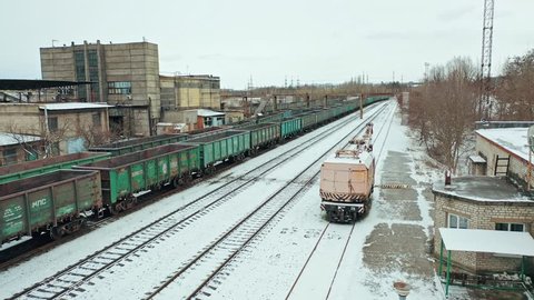 VINNITSA, UKRAINE - FEBRUARY 2019: Four rows of containers are located at the railway station near the state building outside the city. Aerial view.