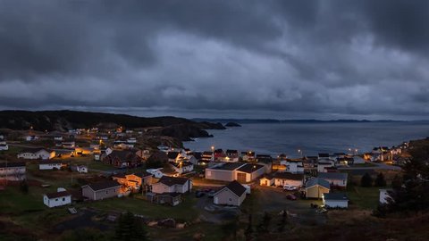 Panoramic view of a small town on the Atlantic Ocean Coast during a dark cloudy sunset. Taken in Crow Head, North Twillingate Island, Newfoundland and Labrador, Canada. Still Image Animation