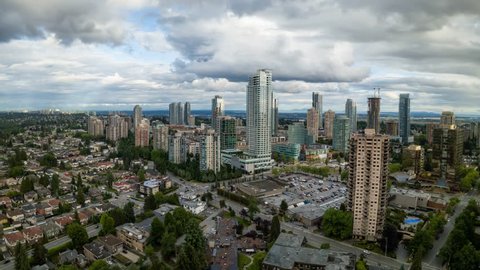 Aerial Panoramic view of residential homes in a modern city during a vibrant summer cloudy day. Taken in Burnaby, Vancouver, BC, Canada. Still Image Continuous Animation
