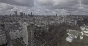 4K. Aerial view of tall buildings and city streets in Warsaw Poland. Video filmed from drone in RAW.