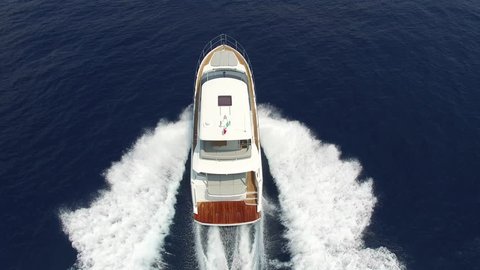 Perpendicular aerial view yacht cruising in the Mediterranean at full speed
