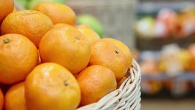 Footage of box of fresh oranges fruits selling at grocery store.Food department at the supermaket store.Close up,focus on orange fruit in basket.Buy and eat healthy natural vitamines for strong health