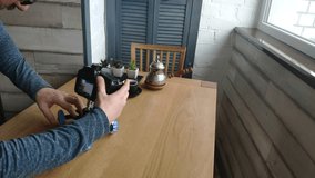 A photographer takes a video with a coffee composition, slow-motion
