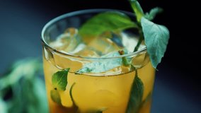 Footage of fresh natural alcohol coctail with rum, basil leaves & lemon lime.Enjoy delicious alocohil drinks in the bar.Coctails for the hot summer season.