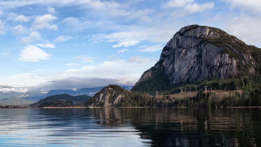 Beautiful panoramic Canadian landscape view of a popular landmark, Chief Mountain, during a cloudy sunny day. Taken in Squamish, North of Vancouver, BC, Canada. Still Image Continuous Animation