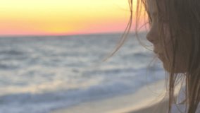 privacy, portrait of a beautiful girl on the beach at sunset, hair moving in the wind, Healthy Lifestyle 4K UHD video