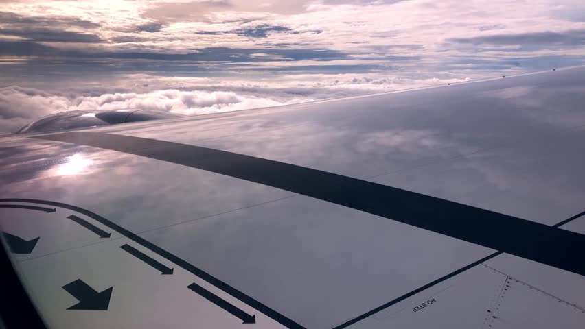 Majestic video of the sun and clouds reflecting on an airplane wing in the sky