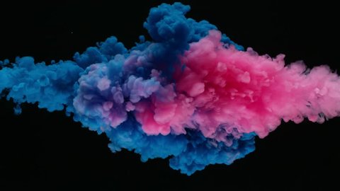 Super slow motion of coloured inks in water. Isolated on black background. Filmed on high speed cinema camera.

