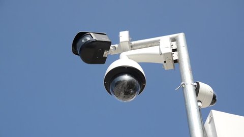 Professional Security cameras scanning the street. Recording video with cam in 4K. CCTV camera on the pole. Concept of surveillance, privacy, criminal, technology, spy, equipment,protection and safety